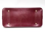 the large burgundy leather tray has two handles on each side of the tray