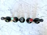 three bottles of wine are lined up on a marble surface