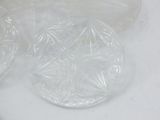 three clear plastic plates sitting on a white surface