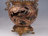 a vase that is sitting on a stand with a dragon on it