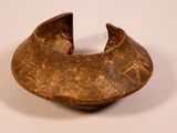 a close up of a brown bowl with designs on it
