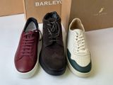 three pairs of shoes are lined up in front of a box
