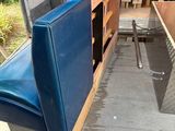 a blue couch sitting in the back of a truck