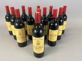 six bottles of red wine lined up in a row