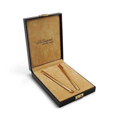 an open box with two pens and a pair of scissors in it