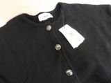 a close up of a black shirt with a tag on it
