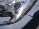 a close up of a car ' s headlight with a reflection on it