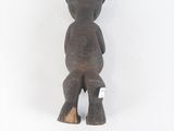 wooden statue of a man with a hat on his head