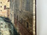a painting on the wall of a building with a boat in the water