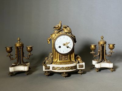 three different types of clocks sitting on a table