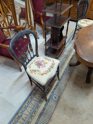several chairs and a table in a room with a rug on the floor