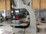 a machine that is sitting in a building with a lot of wood