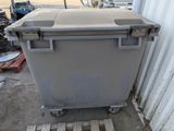 a large gray trash can sitting on a pallet