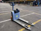 a forklift sitting in the middle of a parking lot