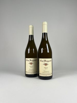 two bottles of wine sitting next to each other on a table