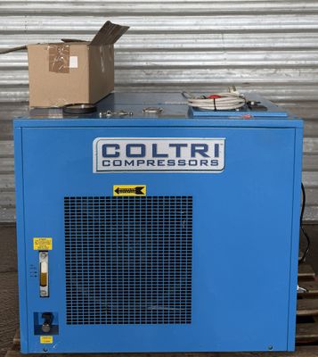 an image of a blue compressor sitting on top of a pallet