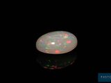 a white oplite in the dark with a black background
