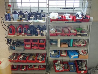 many different types of tools on the shelves in the garage