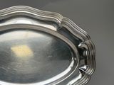 a silver tray with a handle on a table