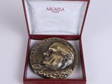 an image of a silver medal in a red box on a white surface