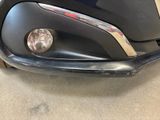 a close up of a car ' s headlight and front bumper