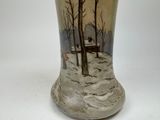 a vase that has a picture of a house on it