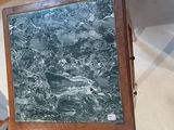a picture of a painting on a table with a chair in the background
