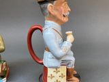 two figurines of a man and a woman sitting on a stool