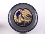 a plate with a picture of a man and a dog on it