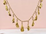 a gold plated necklace with five charms hanging from it