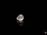 an image of a clear glass object on a black surface