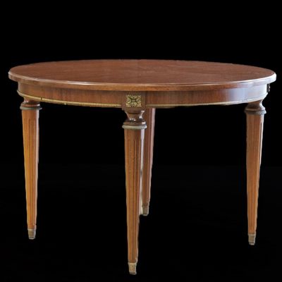 une table à manger ovale à deux pieds, avec un plateau en bois