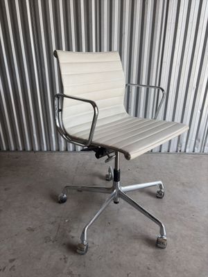 an image of a white office chair in front of a corrugated wall