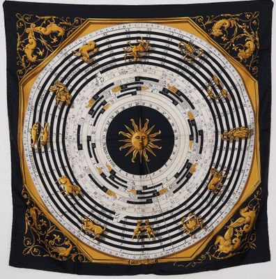 a black and gold scarf hanging on a wall