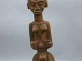 a wooden statue of a man with a hat on his head