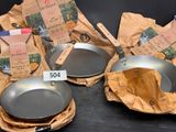 several pots and pans are sitting on a table with a price tag
