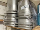 several pans are stacked on a shelf in a kitchen