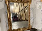 a mirror that is sitting on the floor in a room