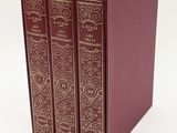 the three books are lined up in a row on a white surface