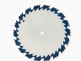 a close up of a circular saw blade on a white surface