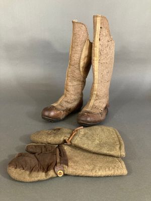 two pairs of boots and mitts are sitting on a table