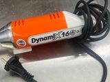 an orange and white electric drill sitting on top of a metal table