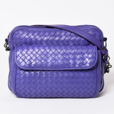 a purple cross body bag on a white background