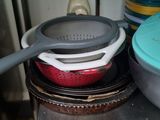 pots and pans are stacked on top of each other in a kitchen