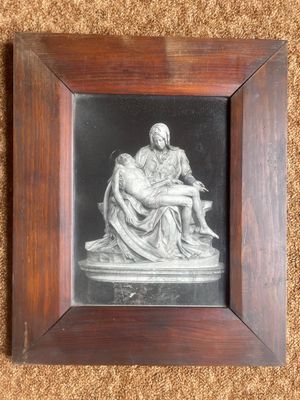 a black and white photo of a framed picture of a woman holding a child