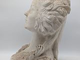 sculpture of a woman ' s head on a white background