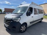 the white van is parked in the parking lot outside of the building