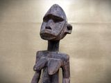 a wooden statue of a man with a hat on