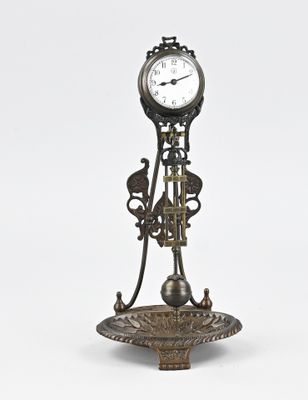 a clock that is on a stand on a white background