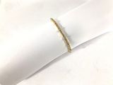 yellow gold plated ring with a thin band on a white napkin